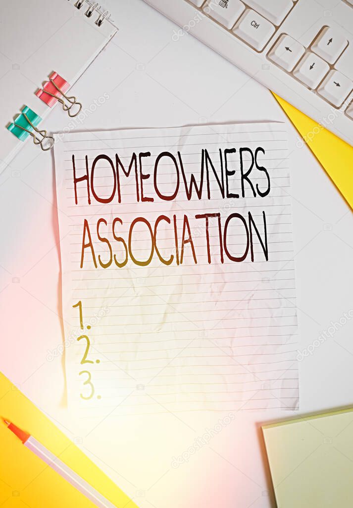 Writing note showing Homeowners Association. Business photo showcasing Organization with fee for upkeeps of Gated Community Colored paper different sizes binder clip sheets white desk empty space.