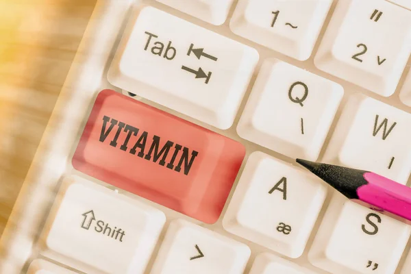 Conceptual hand writing showing Vitamin. Business photo showcasing group of organic compounds which are essential for normal growth. — Stockfoto