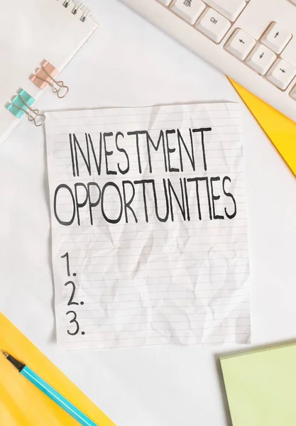 Writing note showing Investment Opportunities. Business photo showcasing a Purchase that has a chance to Gain Value Colored paper different sizes binder clip sheets white desk empty space. — Stock Photo, Image