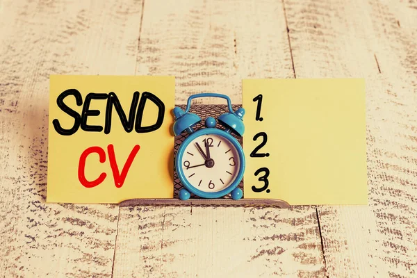 Text sign showing Send Cv. Conceptual photo pass resume to identify the skills or talents specific to the job Mini blue alarm clock standing above buffer wire between two notation paper.