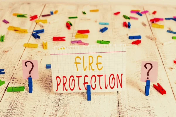 Word writing text Fire Protection. Business concept for measures taken to prevent fire from becoming destructive Scribbled and crumbling sheet with paper clips placed on the wooden table.