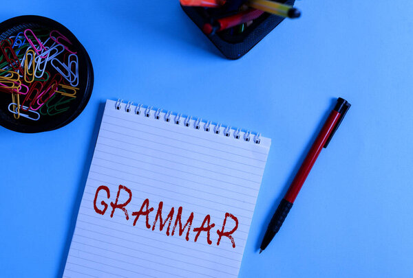 Word writing text Grammar. Business concept for whole system and structure of a language or languages in general Notebook and writing equipment with computer mouse above pastel backdrop.