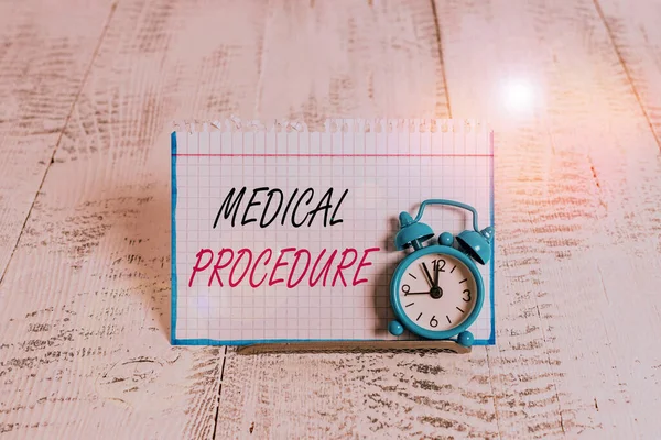 Word writing text Medical Procedure. Business concept for a procedure employed by medical or dental practitioners Mini blue alarm clock stand tilted above buffer wire in front of notepaper.