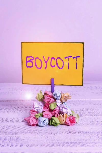 Writing note showing Boycott. Business photo showcasing stop buying or using the goods or services of a certain company Reminder pile colored crumpled paper clothespin wooden space.