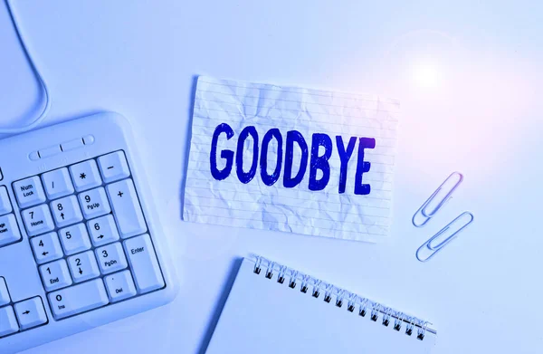 Handwriting text Goodbye. Concept meaning used to express good wishes when parting or end of a conversation White pc keyboard with empty note paper above white background. — 스톡 사진
