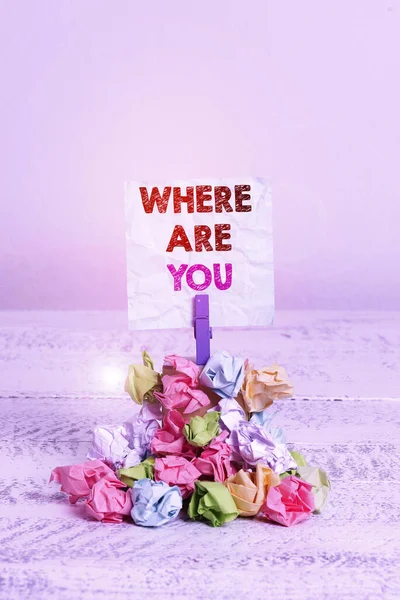 Handwriting text Where Are You. Concept meaning Give us your location address direction point of reference Reminder pile colored crumpled paper clothespin reminder white wooden space.