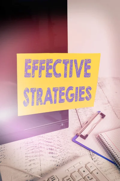 Handwriting text writing Effective Strategies. Concept meaning Sound Tactical Scheme Powerful Operational Decisions Note paper taped to black computer screen near keyboard and stationary. — Stock Photo, Image