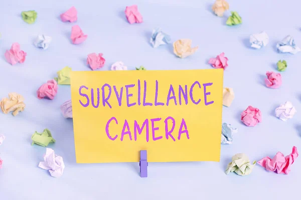 Text sign showing Surveillance Camera. Conceptual photo Closed Circuit Television transmit signal on monitors Colored crumpled papers empty reminder blue floor background clothespin. — Stock Photo, Image