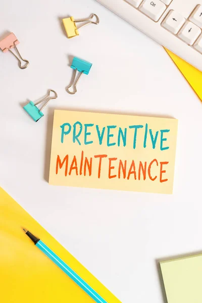 Conceptual hand writing showing Preventive Maintenance. Business photo showcasing Avoid Breakdown done while machine still working Flat lay with pc keyboard and copy space for text messages.