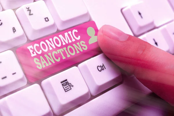 Handwriting text Economic Sanctions. Concept meaning Penalty Punishment levied on another country Trade war.