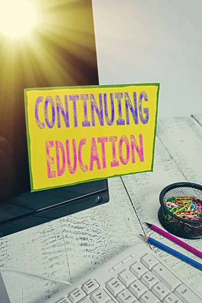 Handwriting text Continuing Education. Concept meaning Continued Learning Activity professionals engage in Note paper taped to black computer screen near keyboard and stationary. — Stock Image Handwriting text Continuing Education. Concept meaning Continued Learning Activity professionals engage in Note paper taped to black computer screen near keyboard and stationary. Royalty Free Stock Photos