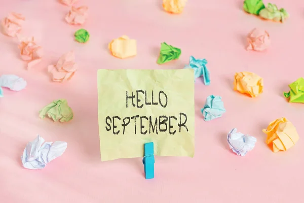 Conceptual hand writing showing Hello September. Business photo text Eagerly wanting a warm welcome to the month of September Colored crumpled papers empty reminder pink floor clothespin. — Stock Photo, Image