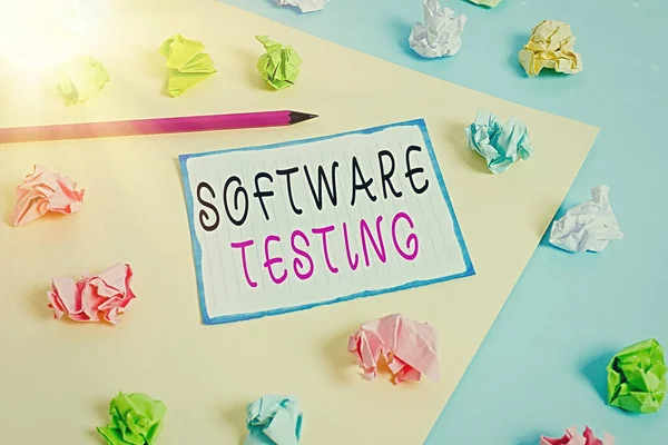 Handwriting text Software Testing. Concept meaning investigation provide information about the quality of it Colored crumpled papers empty reminder blue yellow background clothespin.