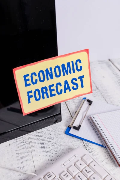 Conceptual hand writing showing Economic Forecast. Business photo text Process of making predictions about the economy condition Note paper taped to black screen near keyboard stationary. — Stock Photo, Image