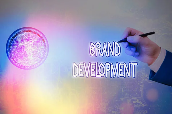 Writing note showing Brand Development. Business photo showcasing Defining the product to excel in the market Promoting Elements of this image furnished by NASA.