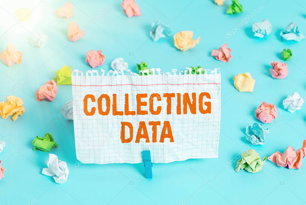 Text sign showing Collecting Data. Conceptual photo Gathering and measuring information on variables of interest Colored crumpled papers empty reminder blue floor background clothespin.