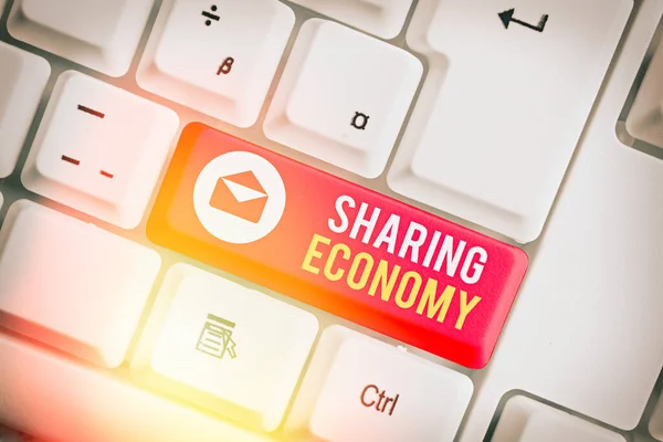 Writing note showing Sharing Economy. Business photo showcasing economic model based on providing access to goods .