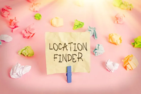 Conceptual hand writing showing Location Finder. Business photo text A service featured to find the address of a selected place Colored crumpled papers empty reminder pink floor clothespin. — Stock Photo, Image