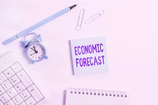 Conceptual hand writing showing Economic Forecast. Business photo text Process of making predictions about the economy condition Copy space on empty note paper with clock and pencil on the table. — Stock Photo, Image