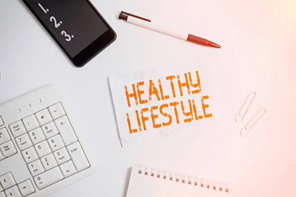 건강 한 생활 양식을 보여 주는 글쓰기. Business photo showcasing Live Healthy Engage in physical activity and exercise Flat lay above computer mobile phone pencil and copy space note paper. — 스톡 사진