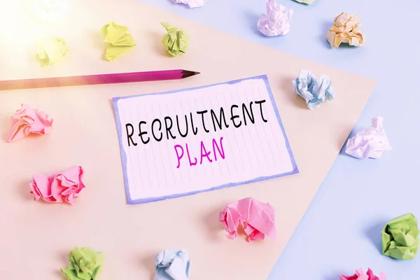 Handwriting text Recruitment Plan. Concept meaning saving money in order to use it when you quit working Colored crumpled papers empty reminder blue yellow background clothespin.