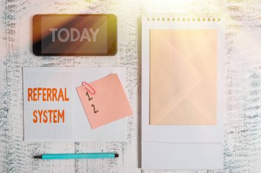 Referans sistemini gösteren kavramsal el yazısı. İş fotoğrafı gösterimi, tedavi için kendi hastasını başka bir doktora gönderiyor. Spiral not defteri, akıllı telefon, yapışkan ahşap arka plan..