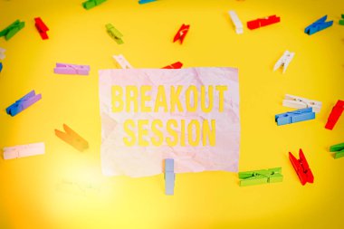 Word writing text Breakout Session. Business concept for workshop discussion or presentation on specific topic Colored clothespin papers empty reminder yellow floor background office. clipart