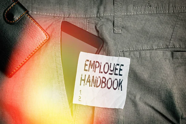Writing note showing Employee Handbook. Business photo showcasing Document that contains an operating procedures of company Smartphone device inside trousers front pocket with wallet.