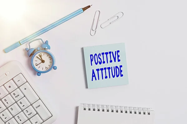 Conceptual hand writing showing Positive Attitude. Business photo text Being optimistic in Life Looking for good things Copy space on empty note paper with clock and pencil on the table.