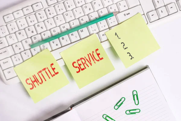 Handwriting text writing Shuttle Service. Concept meaning vehicles like buses travel frequently between two places Three empty green square papers by the pc keyboard with copy space.