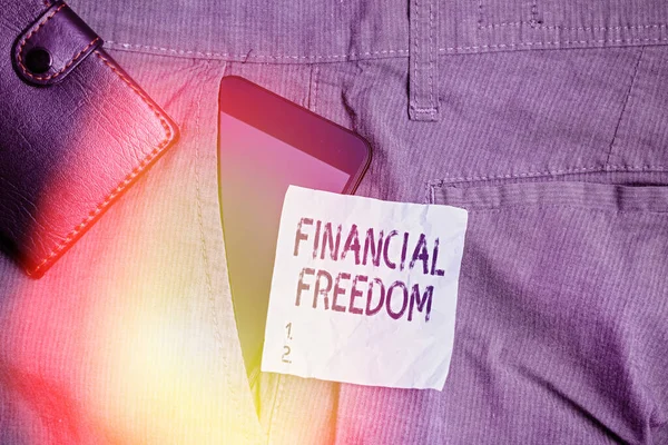 Writing note showing Financial Freedom. Business photo showcasing Having money Free from worry when it comes to cash flow Smartphone device inside trousers front pocket with wallet.