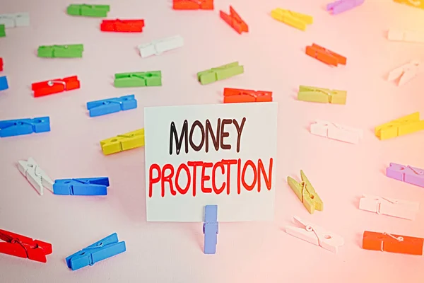 Word writing text Money Protection. Business concept for protects the rental money tenant pays to landlord Colored clothespin papers empty reminder pink floor background office pin.