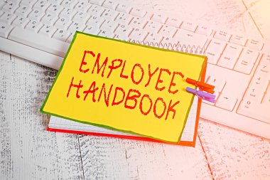 Çalışan El Kitabı 'nı gösteren bir not yazıyorum. Şirket not defteri hatırlatma broşürünün işletim prosedürlerini içeren iş fotoğrafı sergisi belgesi..