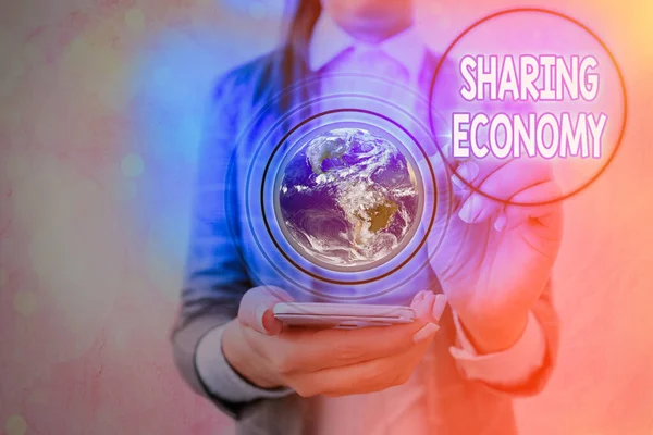 Writing note showing Sharing Economy. Business photo showcasing economic model based on providing access to goods Elements of this image furnished by NASA. — Stock Photo, Image