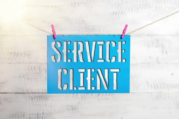 Handwriting text Service Client. Concept meaning Dealing with customers satisfaction and needs efficiently Clothesline clothespin rectangle shaped paper reminder white wood desk. — Stock Photo, Image