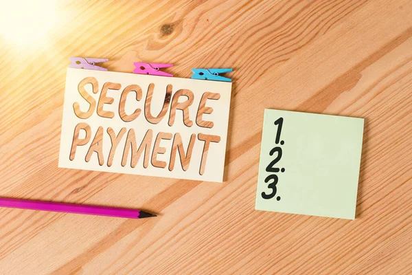 Conceptual hand writing showing Secure Payment. Business photo text Security of Payment refers to ensure of paid even in dispute Colored crumpled papers wooden floor background clothespin.