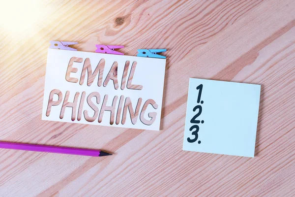 Conceptual hand writing showing Email Phishing. Business photo text Emails that may link to websites that distribute malware Colored crumpled papers wooden floor background clothespin.