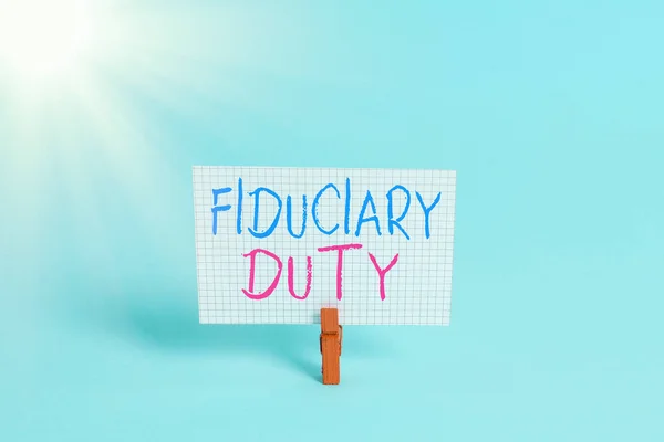 Conceptual hand writing showing Fiduciary Duty. Business photo showcasing A legal obligation to act in the best interest of other Colored clothespin rectangle shaped paper blue background.