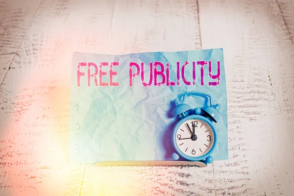 Text sign showing Free Publicity. Conceptual photo Promotional marketing Mass media Public Relations Editorial Mini blue alarm clock stand tilted above buffer wire in front of notepaper. — Stock Photo, Image