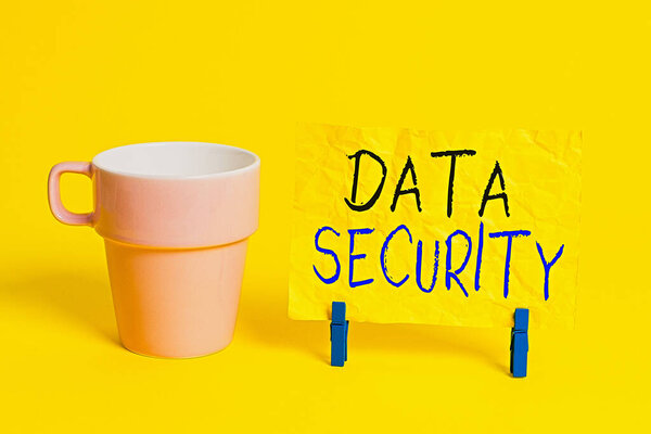 Conceptual hand writing showing Data Security. Business photo showcasing Confidentiality Disk Encryption Backups Password Shielding Paper blue clothespin rectangle shape reminder yellow office.