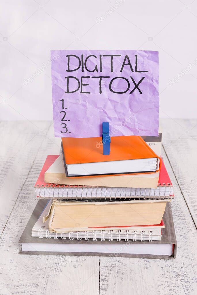 Handwriting text Digital Detox. Concept meaning Free of Electronic Devices Disconnect to Reconnect Unplugged pile stacked books notebook pin clothespin colored reminder white wooden.