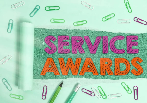 Writing note showing Service Awards. Business photo showcasing Recognizing an employee for his or her longevity or tenure.