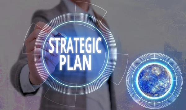 Conceptual hand writing showing Strategic Plan. Business photo text A process of defining strategy and making decisions Elements of this image furnished by NASA. — Stock Photo, Image