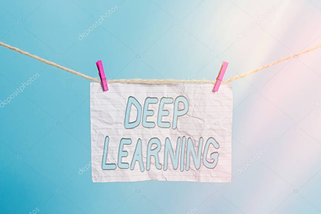 Handwriting text Deep Learning. Concept meaning Hierarchical Abstractions Artificial Intelligence Algorithm Clothesline clothespin rectangle shaped paper reminder white wood desk.