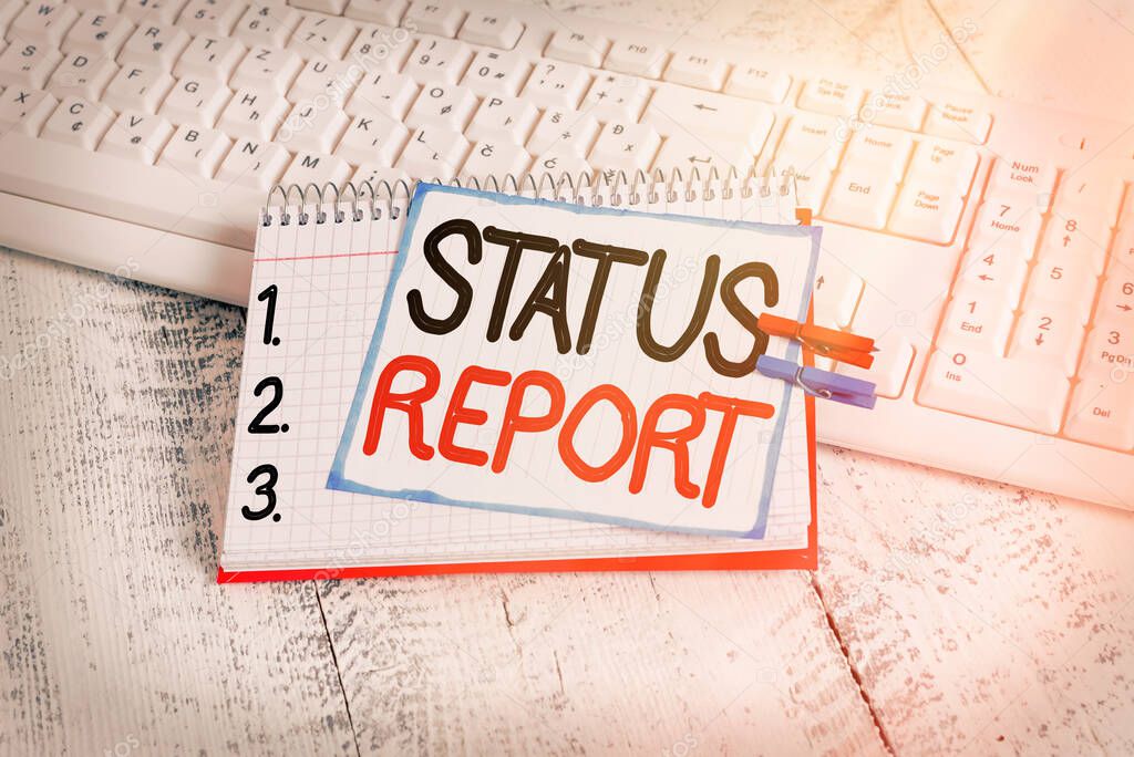 Text sign showing Status Report. Conceptual photo Update Summary of situations as of a period of time notebook paper reminder clothespin pinned sheet white keyboard light wooden.
