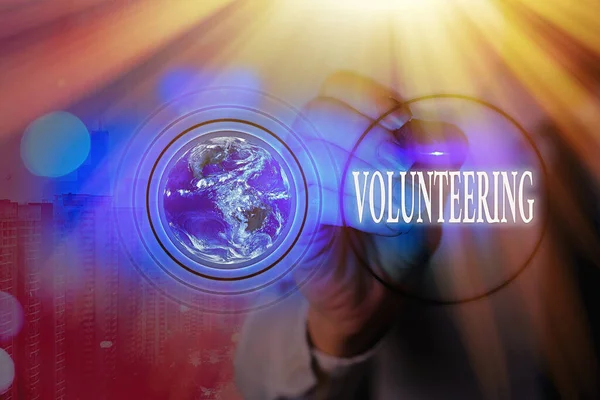 Writing note showing Volunteering. Business photo showcasing Provide services for no financial gain Willingly Oblige Elements of this image furnished by NASA. — Stock Photo, Image