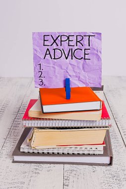 Handwriting text Expert Advice. Concept meaning Sage Good Word Professional opinion Extensive skill Ace pile stacked books notebook pin clothespin colored reminder white wooden. clipart