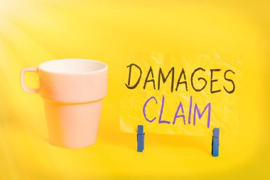 Conceptual hand writing showing Damages Claim. Business photo showcasing Demand Compensation Litigate Insurance File Suit Paper blue clothespin rectangle shape reminder yellow office. clipart