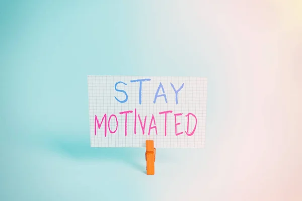 Conceptual hand writing showing Stay Motivated. Business photo showcasing Reward yourself every time you reach a goal with knowledge Colored clothespin rectangle shaped paper blue background. — Stock Photo, Image