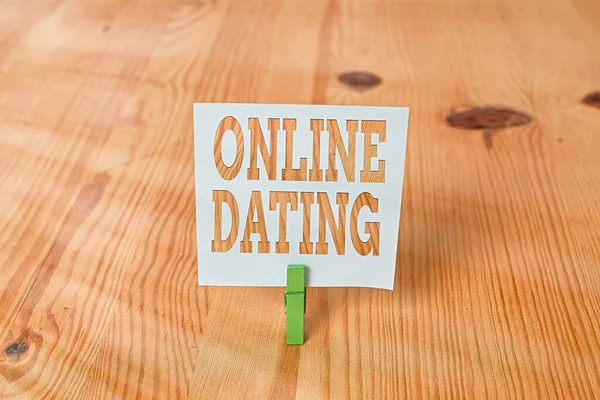 Handwriting text Online Dating. Concept meaning Searching Matching Relationships eDating Video Chatting Empty reminder wooden floor background green clothespin groove slot office. — Stock Photo, Image